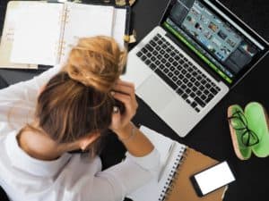 stressed woman at desk no motivation