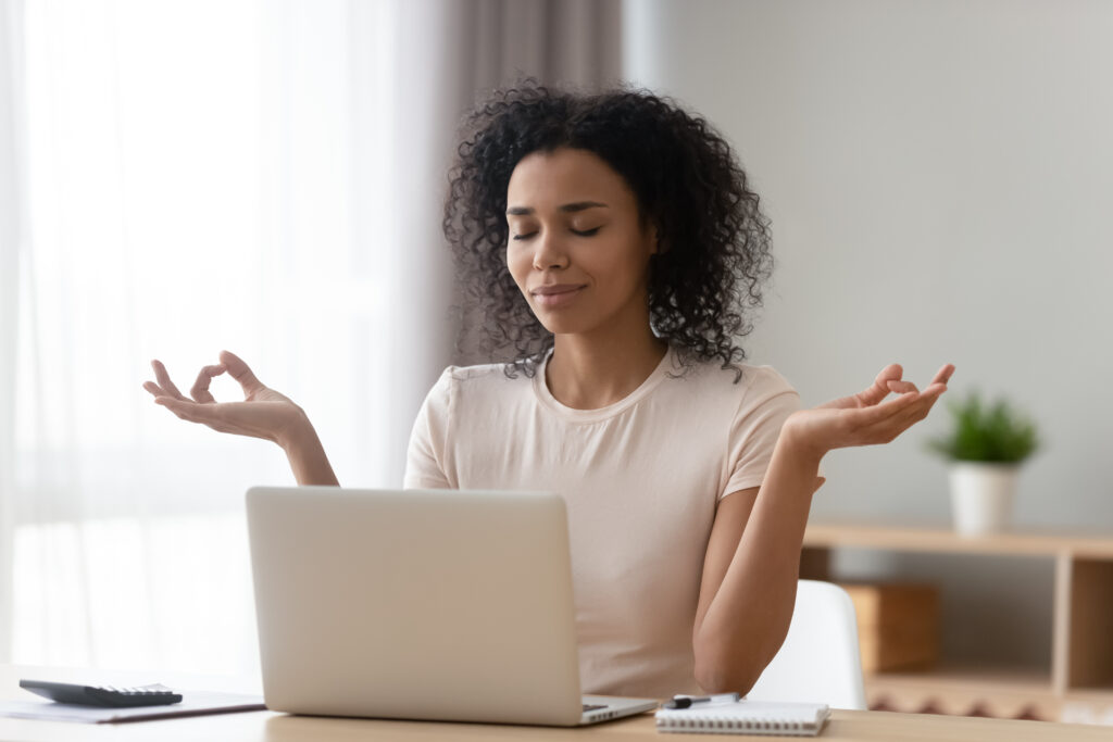 woman meditating at work desk