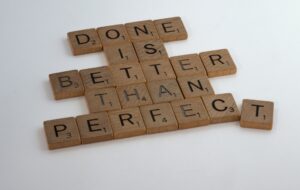 scrabble pieces reading "done is better than perfect"
