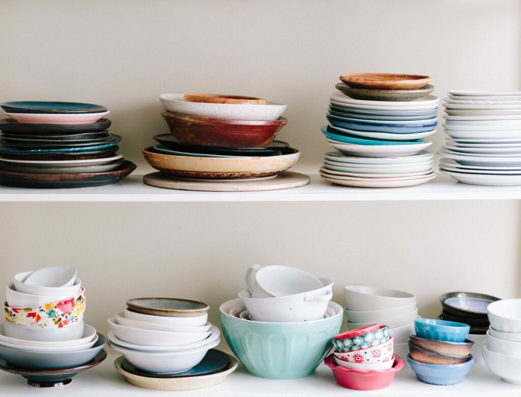 piles of dishes on shelf