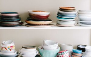piles of dishes on shelf