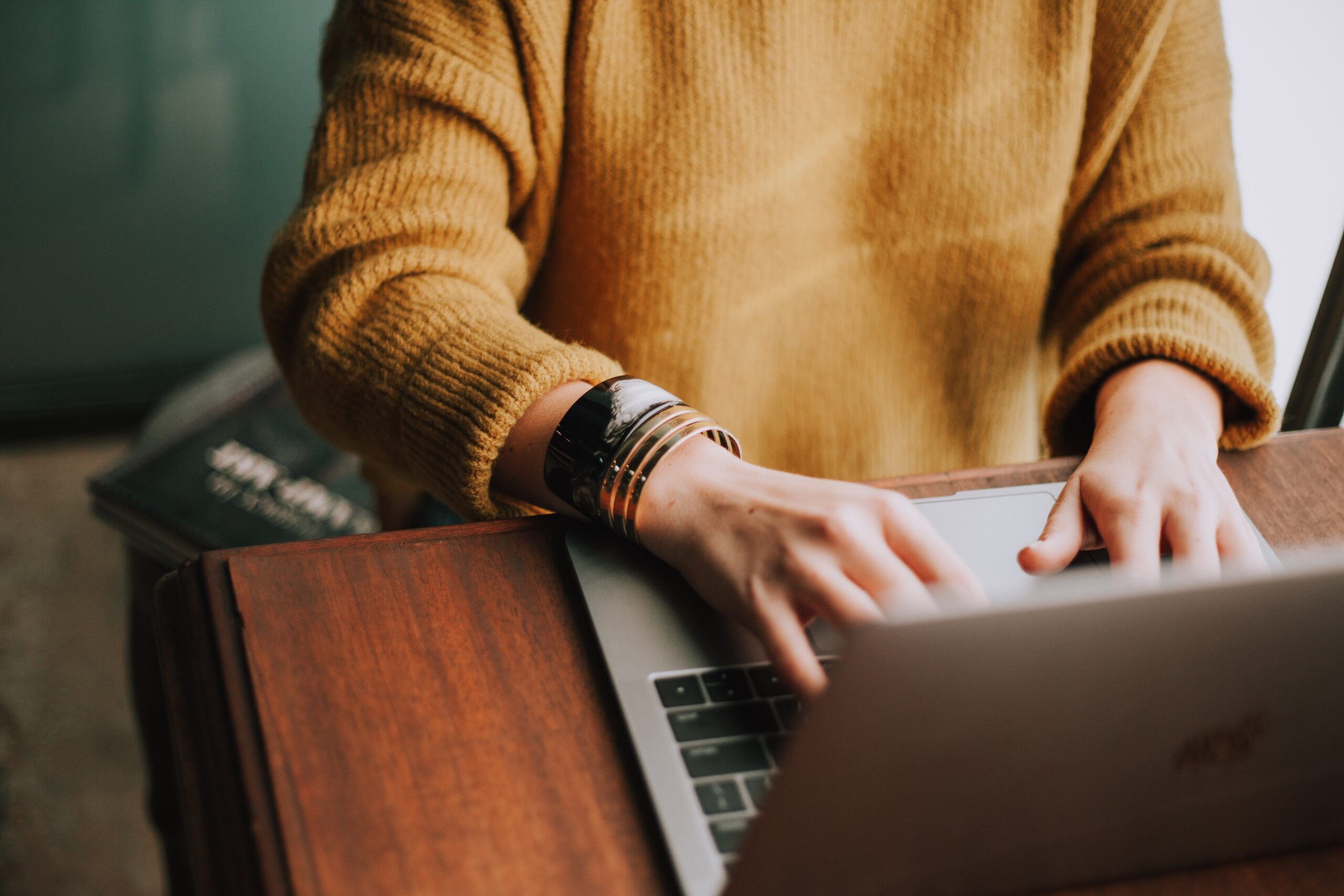 woman typing on laptop.