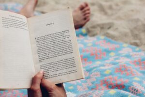 Woman reading at book at the beach.