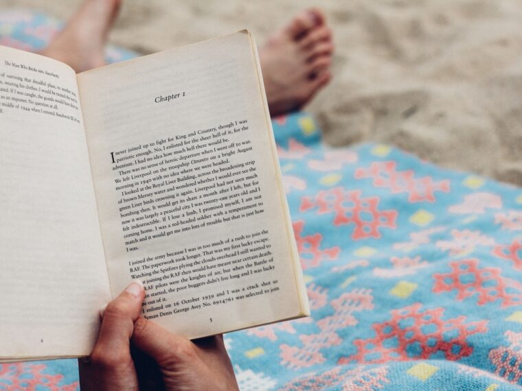 Woman reading at book at the beach.