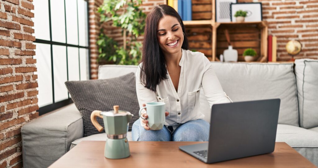 Woman drinking coffee while shopping online.