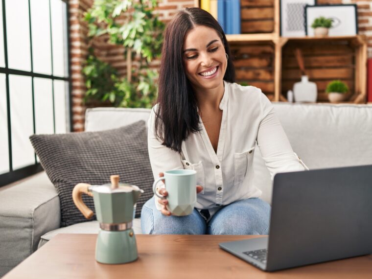 Woman drinking coffee while shopping online.
