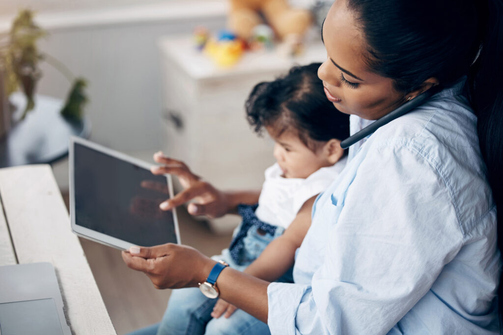 mother working from home taking care of her baby.