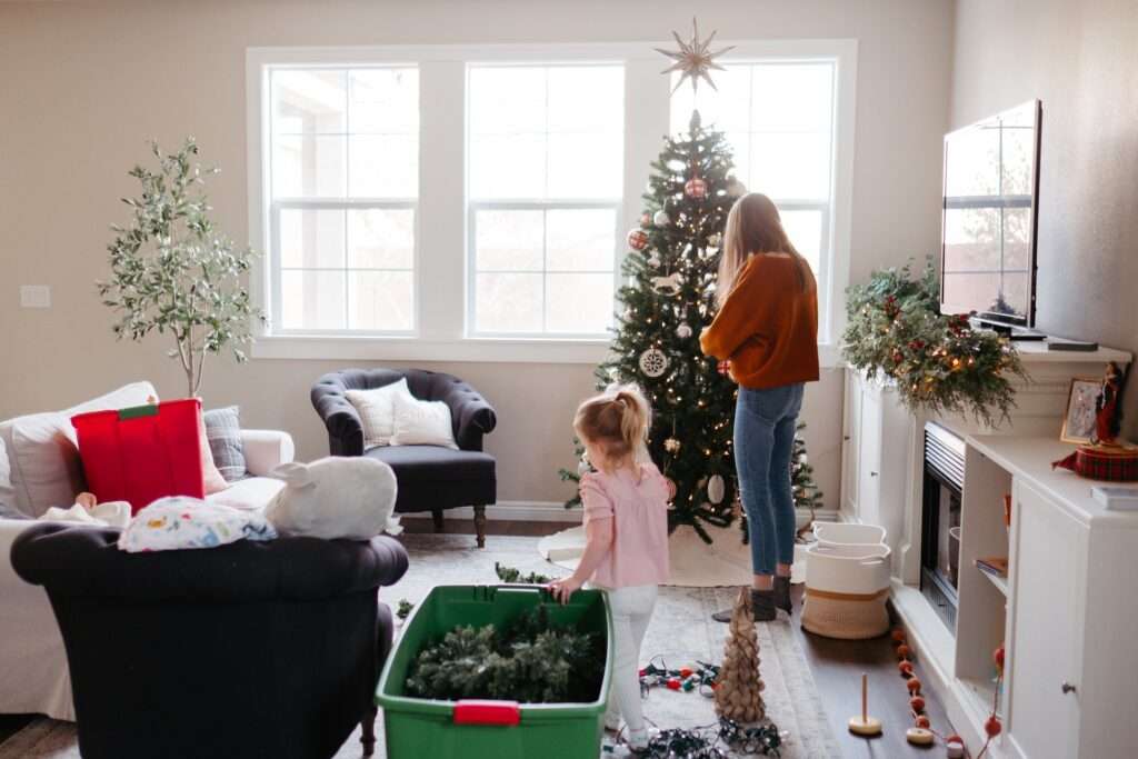 Mom and daughter decorating the tree.